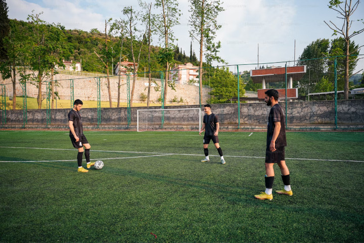 Men Play Soccer/Football in a Green Field